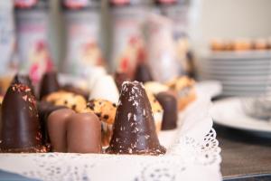 a plate of chocolate covered donuts on a table at LIHO - einfach Lübeck in Lübeck