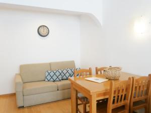 a living room with a couch and a table at Carvoeiro Beach Apartment Luxury in Carvoeiro