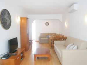 a living room with a couch and a table at Carvoeiro Beach Apartment Luxury in Carvoeiro