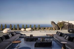 a living room with couches and a view of the ocean at SantAnna Luxury Suites in Imerovigli