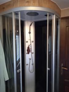 a shower in a room with two glass doors at Sweet home in Charleroi