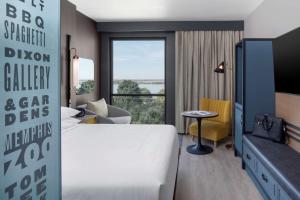 a hotel room with a bed and a large window at Hyatt Centric Beale Street Memphis in Memphis