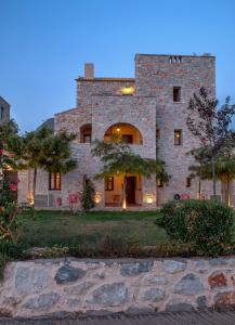 a large stone building with an archway in front of it at Achelatis Traditional Guest Houses in Areopolis