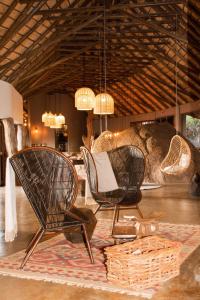 
a living room filled with furniture and a fire place at Madikwe Hills Private Game Lodge in Madikwe Game Reserve
