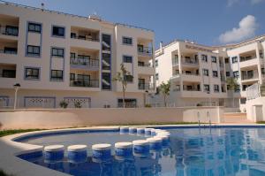 a swimming pool in front of a building at RealRent Calamora I in Moraira