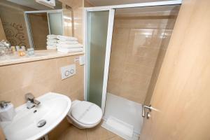 a bathroom with a shower and a toilet and a sink at Hotel Kastel 1700 in Split