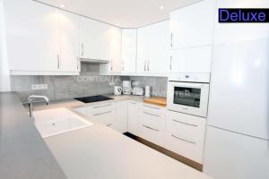 - une cuisine blanche avec des armoires et des appareils blancs dans l'établissement Appartements Cannes Centre Ville, à Cannes