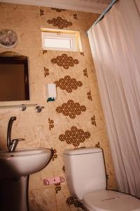 a bathroom with a toilet and a sink at Zeytindali Apart Hotel in Didim