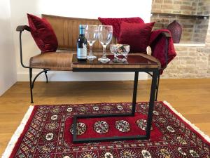 a coffee table with glasses and wine bottles on a rug at Oblivion Luxury Rooms in Split