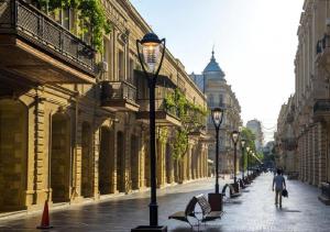 a street with benches and street lights in a city at Grand Midway Hotel in Baku