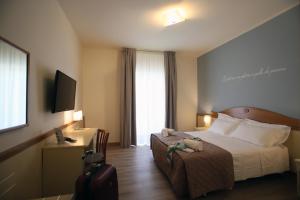 Posteľ alebo postele v izbe v ubytovaní Hotel Le Ginestre Family & Wellness