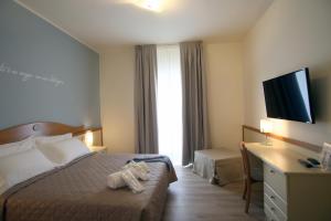 Posteľ alebo postele v izbe v ubytovaní Hotel Le Ginestre Family & Wellness