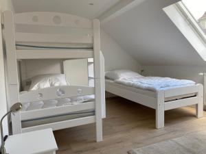 a bedroom with two bunk beds in a attic at interaktiv . Appartements in Heiligenhaus