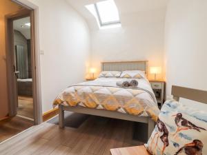 a bedroom with a bed in a room with a mirror at 3 The Barn in Haverfordwest