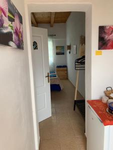 a kitchen with a door open to a room at joy in Lajares