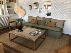 a living room with a couch and a coffee table at Le Homard Bleu in Saint-Trojan-les-Bains