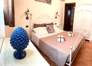 a bedroom with a bed with two shoes on it at Il Cortile in San Vito lo Capo