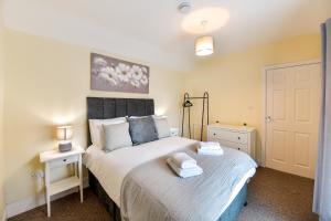 a small bedroom with a bed and a night stand at Host & Stay - Gerald House in Swansea