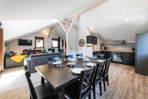 a dining room and kitchen with a table and chairs at LES CHARMETTES in Brides-les-Bains