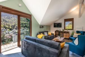a living room with a couch and a table at LES CHARMETTES in Brides-les-Bains