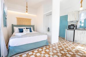 a bedroom with a bed and a kitchen at THE SHIP in Lefkos Karpathou