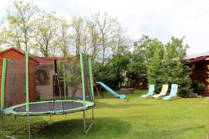 a group of playground equipment in a yard at Eszter Nyaralóház in Zánka