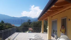a woman standing on the balcony of a house at Casa Magosta in Malcesine
