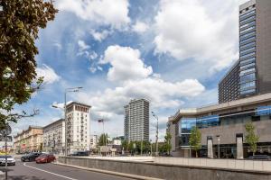 a city street with buildings and cars on the road at ApartLux Novoarbatskaya Superior 2 in Moscow