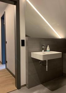 a bathroom with a white sink and a mirror at Eldenholz FeWo8 in Waren +10 photos