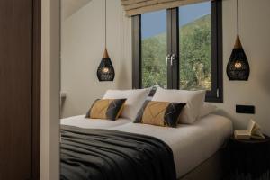 a bedroom with a bed with a large window at Villa Verde in Kallithea