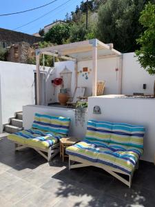 two chairs and a table on a patio at Casa Laryssiou in Gythio