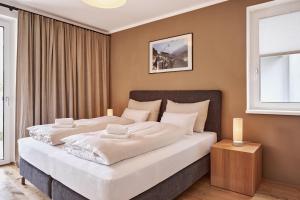 a bedroom with two beds in a room at die Tauplitz Lodges - Wasserfall Lodge C1 by AA Holiday Homes in Tauplitz