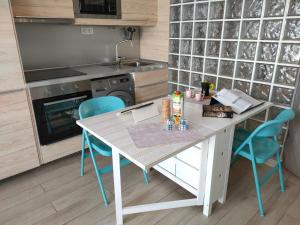 a kitchen with a table and blue chairs at BLU in Puerto del Carmen
