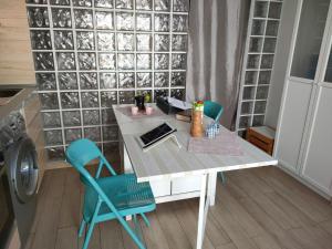 a table and chairs in a room with a wall at BLU in Puerto del Carmen