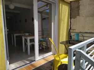 a sliding glass door to a patio with a table and chairs at Albergue O Peirao in A Guarda