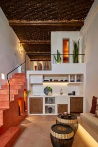 a living room with two tables and a staircase at Domus Hestia Suites in Pirgos