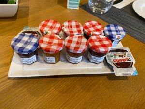 a tray with four jars of food on a table at La Maison du Caillou in Pontarmé