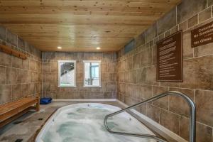 a hot tub in a room with a wooden ceiling at 1014 Wild Irishman condo in Keystone