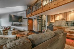 a living room with a large couch and a kitchen at 1014 Wild Irishman condo in Keystone