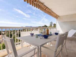 a white dining table and chairs on a balcony at Apartment Les Horizons by Interhome in Cannes