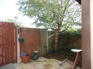 a backyard with a fence and a tree at Charming 1-Bed Apartment in Ardfert Tralee 