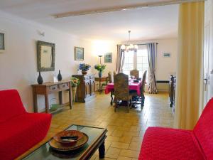 a living room with a red couch and a table at Apartment Princesse by Interhome in Les Issambres