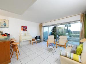 a living room with a couch and a table at Apartment Cannes Bay-2 by Interhome in Cannes