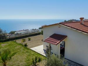 ein weißes Haus mit Meerblick in der Unterkunft Villa Col di Rodi by Interhome in Sanremo