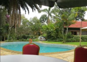 a view of a swimming pool in a house at Tulia Retreat Hotel and Spa in Arusha