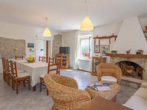 a living room with a table and chairs and a fireplace at Holiday Home Masseria Difesa Grande by Interhome in Montenero di Bisaccia