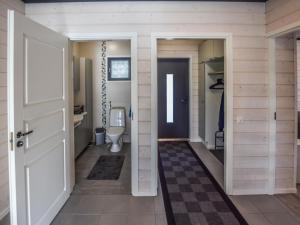 a bathroom with a toilet and a door at Holiday Home Hämyrinne by Interhome in Kokkosenlahti