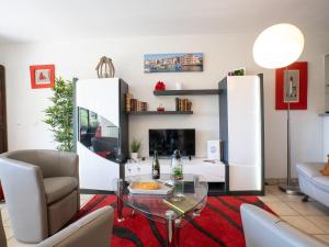 a living room with a glass table and a fireplace at Apartment Parc de Maldagora-3 in Saint-Jean-de-Luz