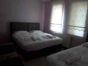Postel nebo postele na pokoji v ubytování Dirilis Banarya Apart hotel