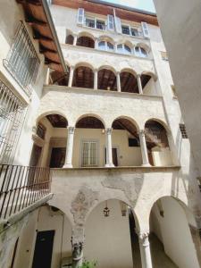 an external view of a building with arches at mille e una notte in Bergamo